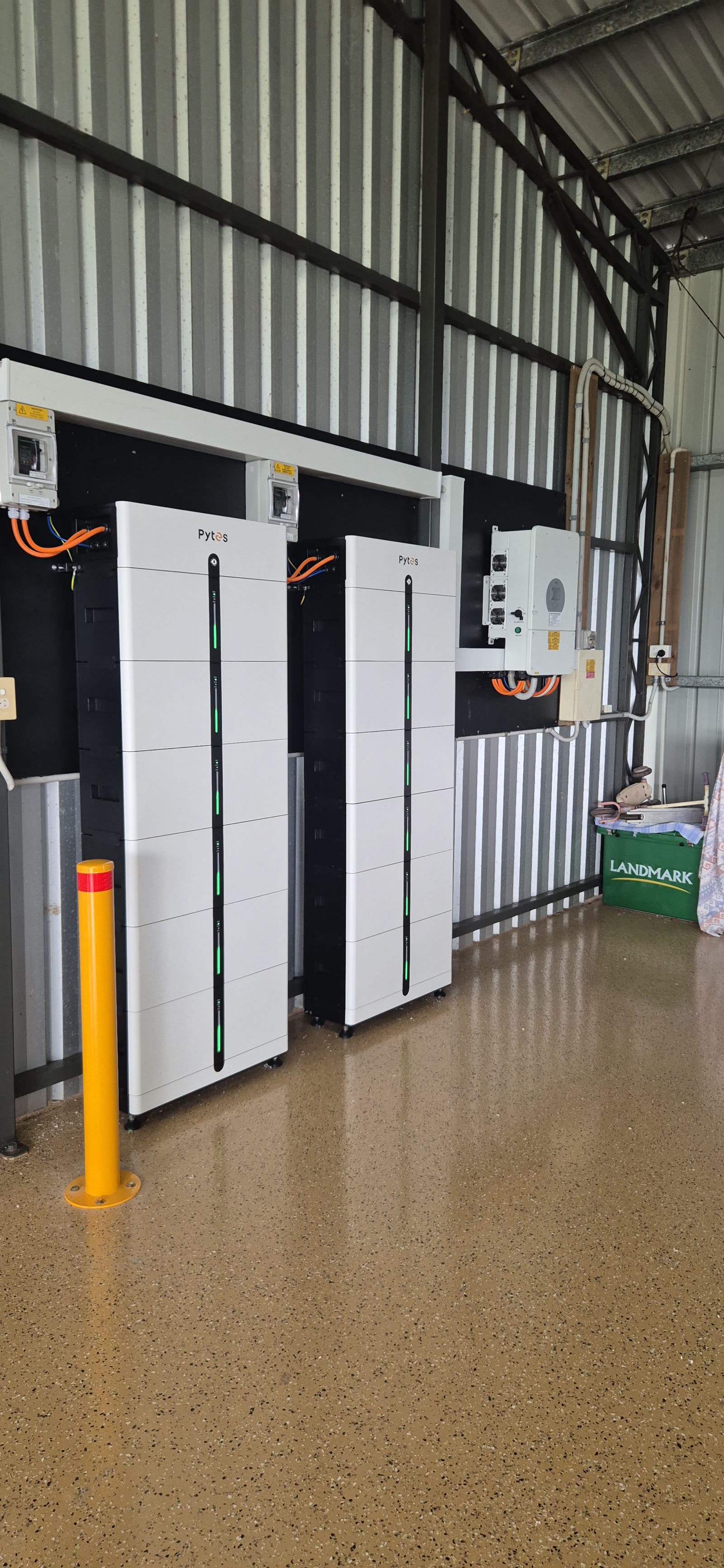 Two Pytes Pi LV1 battery stacks and a Deye inverter in a finished residential garage
