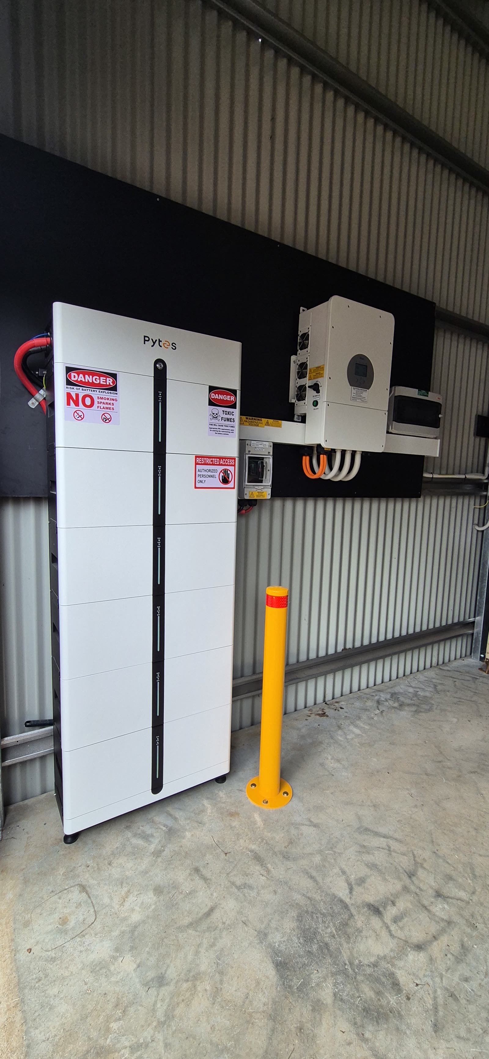 Pytes Pi LV1 batteries and a Deye inverter installed in an open machinery shed